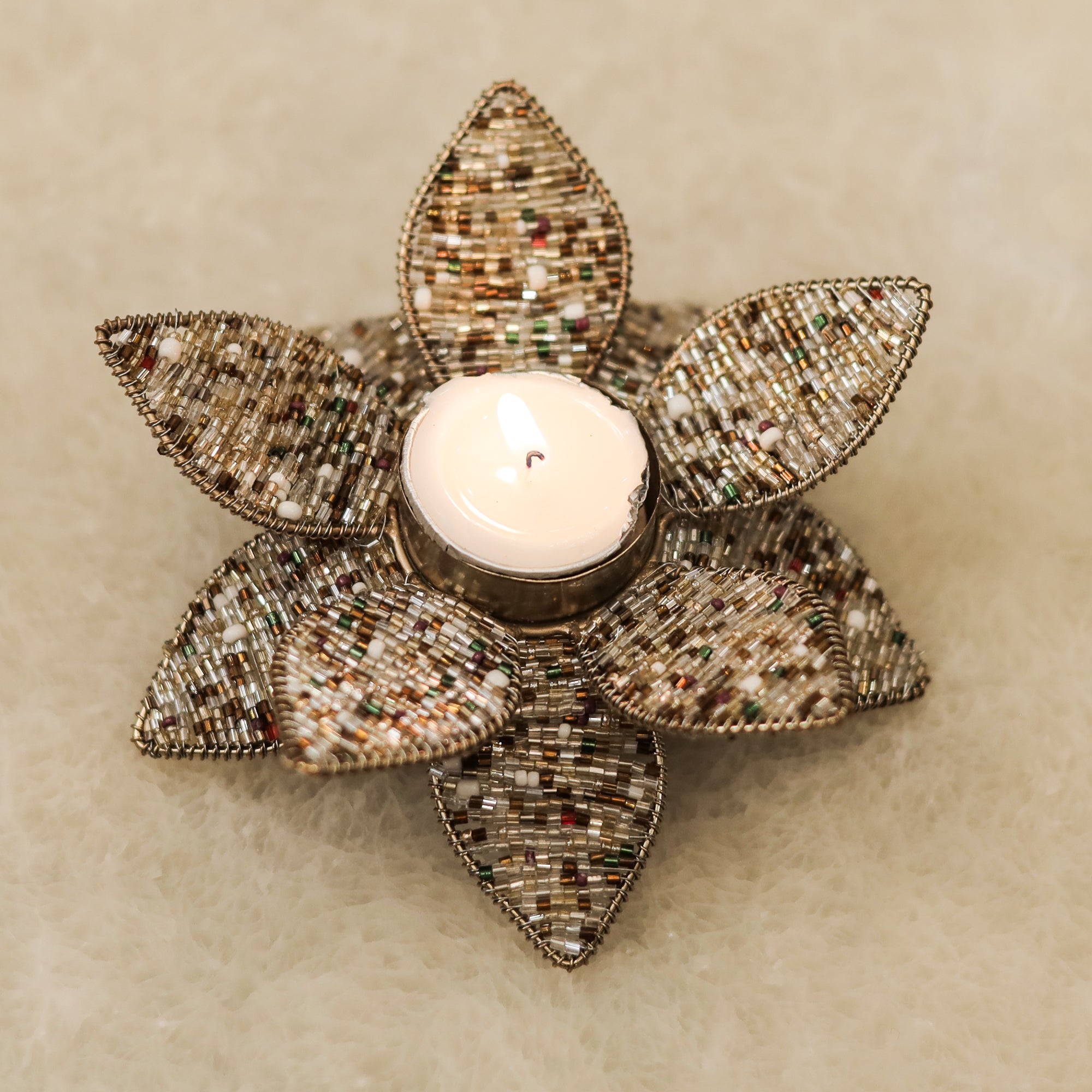 Refined Metal Beaded T-Light Stand for a Luxurious Glow