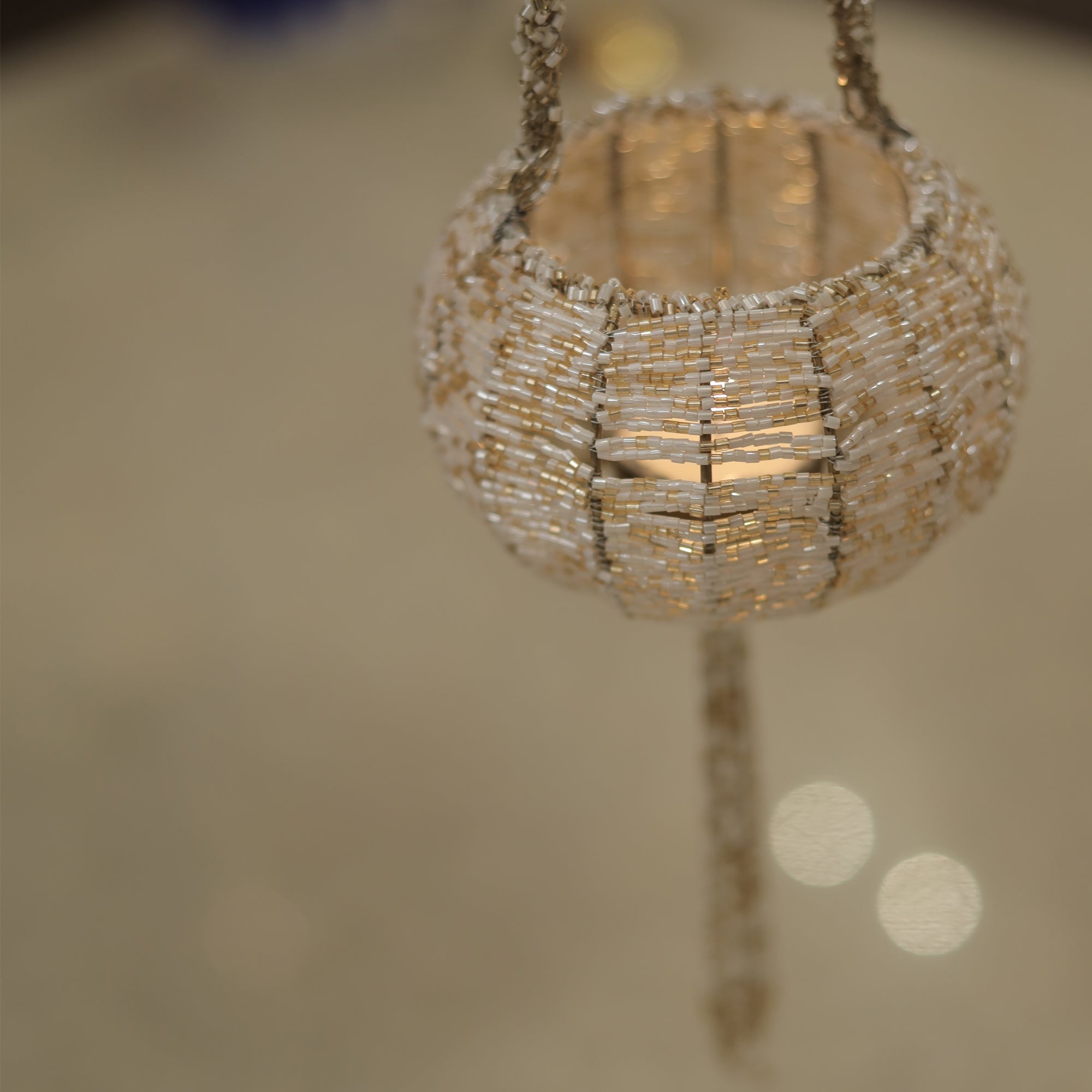 Timeless Metal Beaded T-Light Holder for Warm, Inviting Light