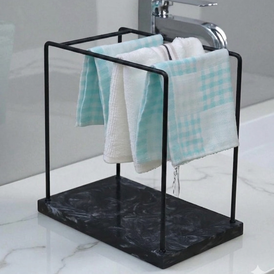  Black towel rack with towels on a marble surface in a bathroom setting 