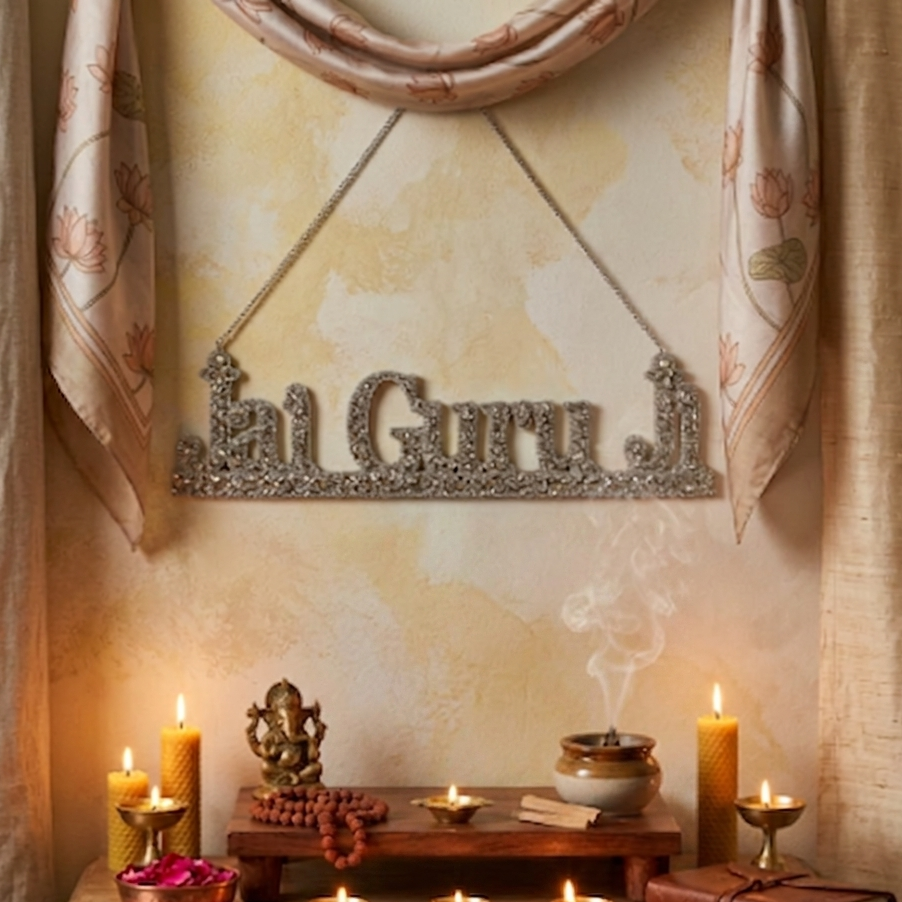  Decorative altar with 'Jai Guru' sign, candles, and religious items on a wooden table. 