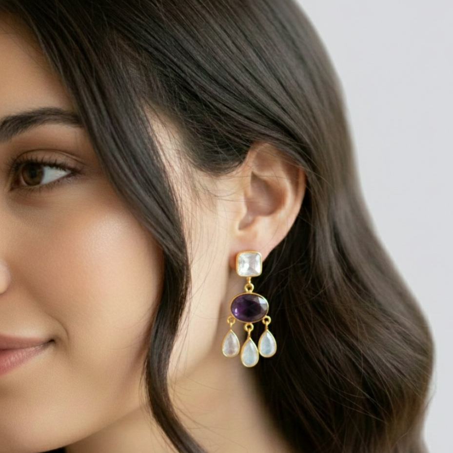  Semiprecious stone studded ear drops, Description- These are gold electroplated danglers studded with beautiful semiprecious Austrian crystals. Tear drop shaped three dangles attached with one violet stone with one square crystal at the top . Very suitable for ethnic wea 